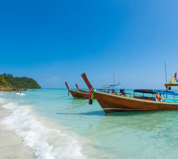 Airplane flying through sky – representing cheap holiday packages including flights and all inclusive travel deals